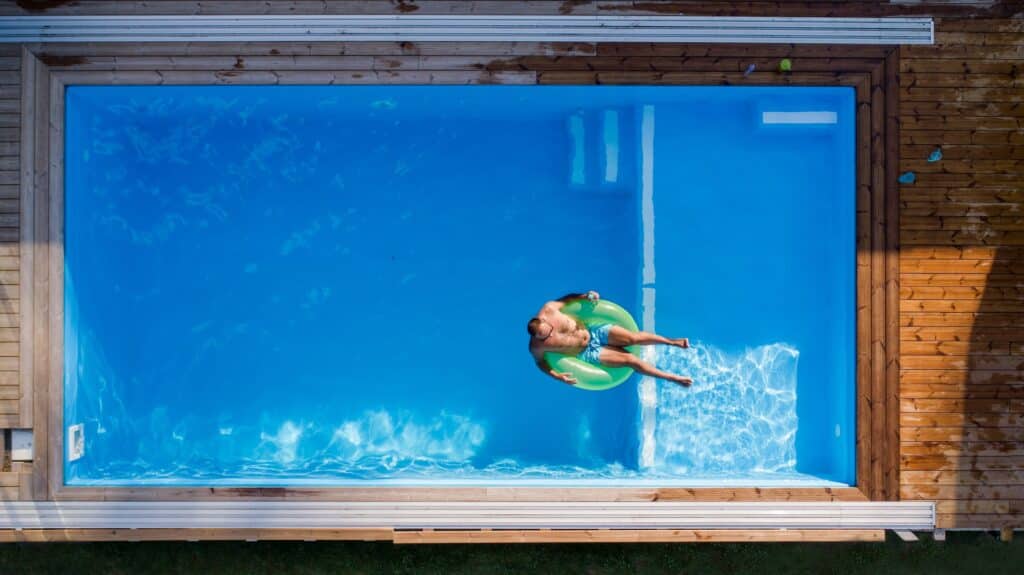 aerial view of man lying in water in swimming pool 2023 11 27 05 09 11 utc scaled