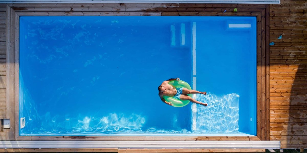 aerial view of man lying in water in swimming pool 2023 11 27 05 09 11 utc scaled